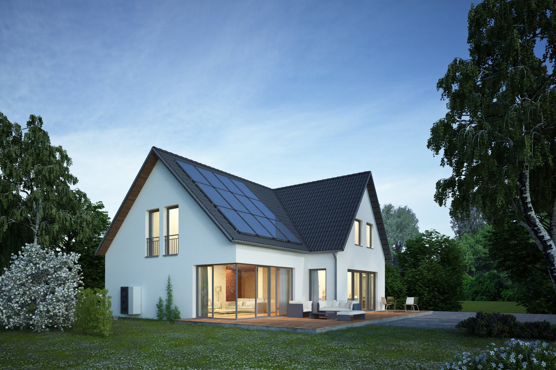 Modernes Einfamilienhaus am Abend mit installierter Wärmepumpe