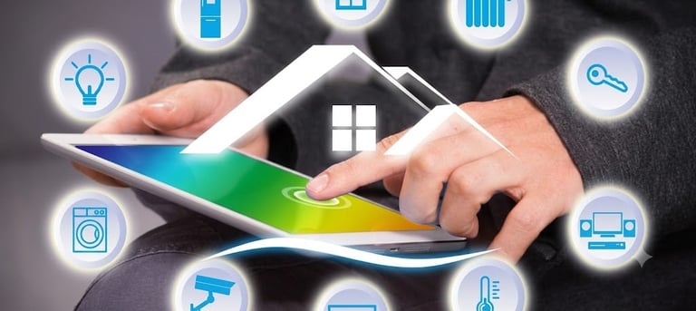 Hands holding a tablet displaying a smart home house icon with surrounding smart home technology symbols including lightbulb, camera, and appliances