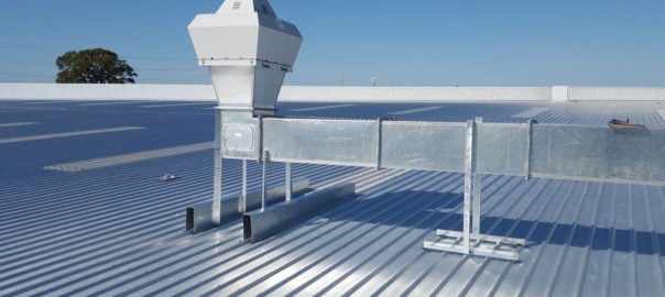 Telescope viewer on a rooftop overlooking ocean and sky on a clear sunny day